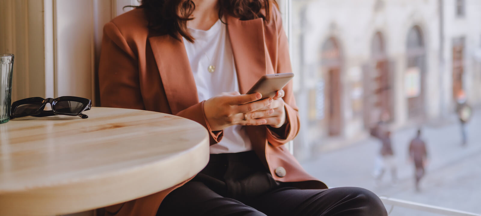 Lady in pink blazer holding phone