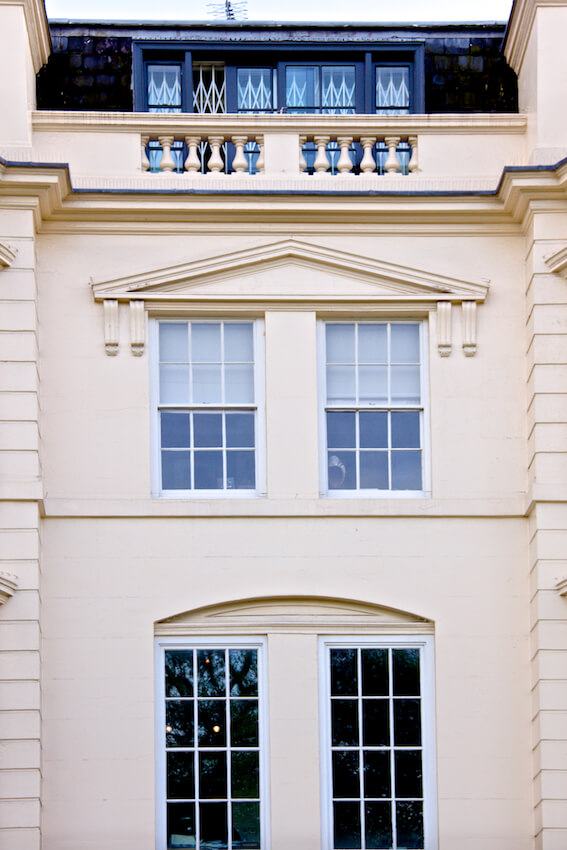 Single glazed traditional sash windows on a cream building