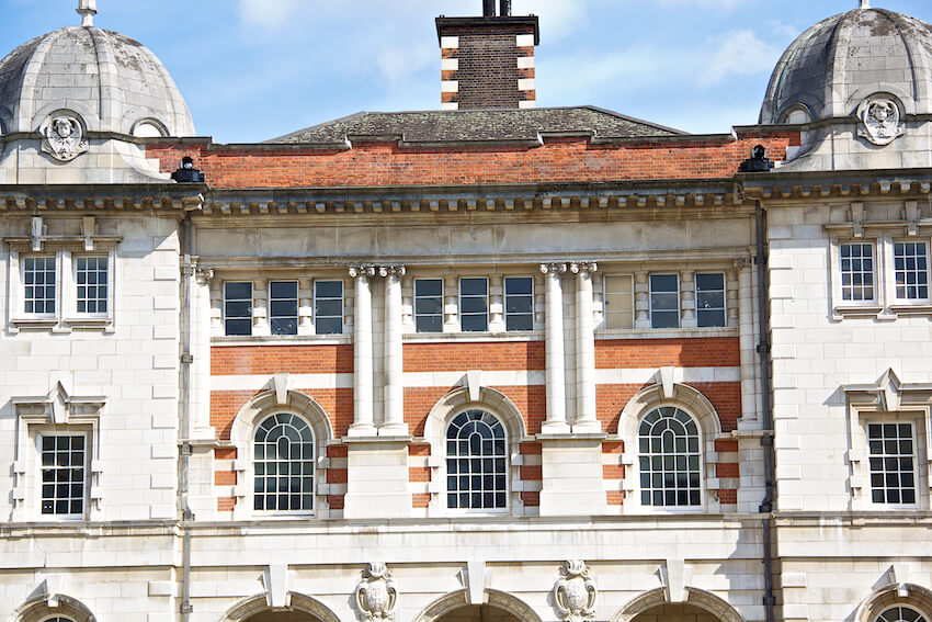 Front of a historic building showing arched sash windows